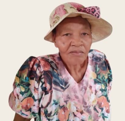 Portrait of Thoko Ndwandwe in a straw hat and floral dress